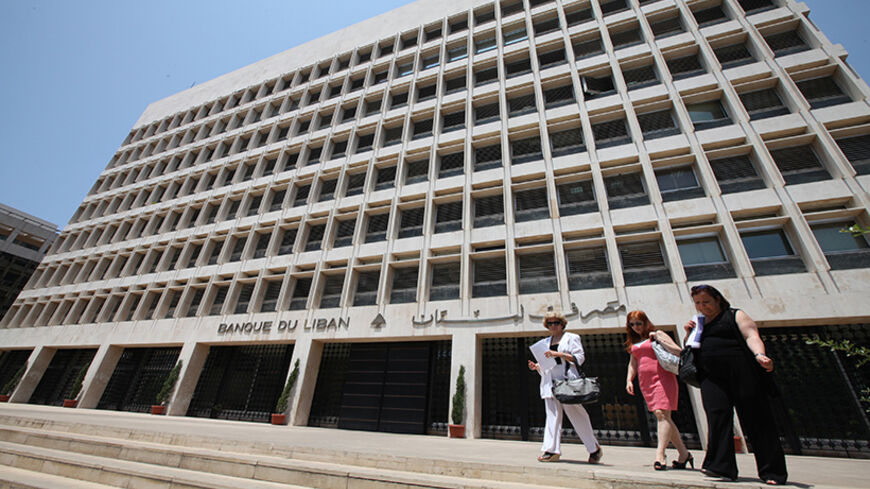 People are seen leaving Lebanon's Central Bank in Beirut July 7, 2011. Lebanese banks which worked for years to build up business in neighbouring Syria have been quietly implementing U.S. and European Union sanctions against Damascus to avoid jeopardising their international operations, bankers and economists say. Picture taken July 7, 2011. To match Feature LEBANON-SYRIA/BANKS REUTERS/Mohamed Azakir (LEBANON - Tags: BUSINESS) - RTR2XHQQ