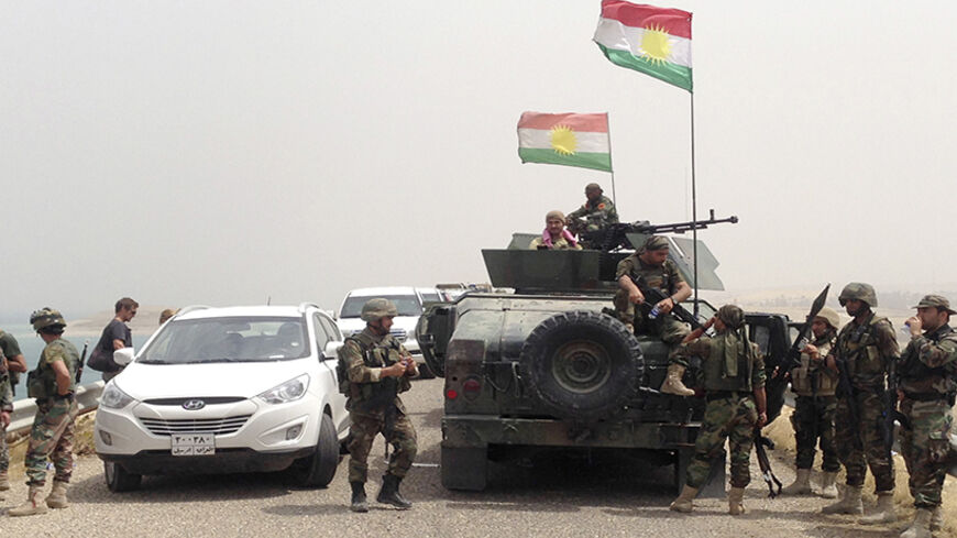 Kurdish fighters stand guard at the Mosul Dam in Mosul in northern Iraq August 19, 2014. Sunni Muslim fighters led by the Islamic State swept through much of northern and western Iraq in June, capturing the Sunni cities of Tikrit and Mosul as well as the Mosul dam, which controls water and power supplies to millions of people down the Tigris river valley. REUTERS/Stringer (IRAQ - Tags: CIVIL UNREST POLITICS MILITARY) - RTR430K7