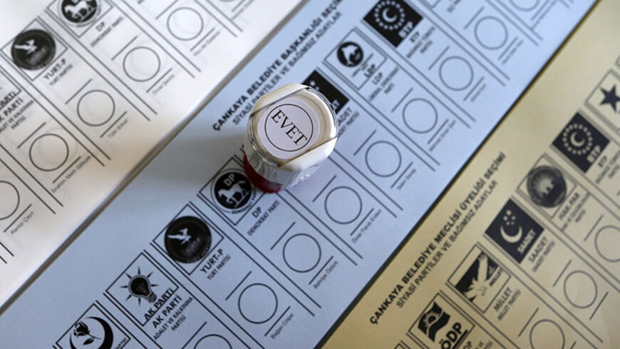 Ballots are seen under a stamp, with the word "yes", at a polling station in Ankara March 30, 2014. Prime Minister Tayyip Erdogan looks set to win Sunday's municipal elections that have become a crisis referendum on his 10-year rule as he tries to ward off graft allegations and stem a stream of damaging security leaks. REUTERS/Umit Bektas (TURKEY - Tags: POLITICS ELECTIONS) - RTR3J6TT