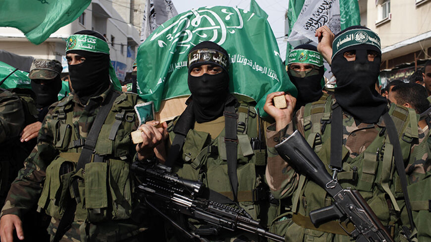 Palestinian Hamas militants carry a coffin containing the body of their comrade Rami Meshmish during his funeral in the central Gaza Strip April 16, 2014. Meshmish and another fellow militant were killed in an accidental explosion on Wednesday; al-Qassam brigades, the armed wing of Hamas movement, said in a statement. REUTERS/Ibraheem Abu Mustafa (GAZA - Tags: POLITICS) - RTR3LJJR