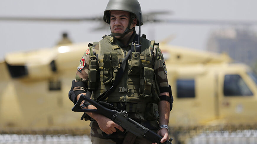 A member of the presidential guards a military helicopter of former army chief Abdel Fattah al-Sisi as he boards it after swearing in as Egypt's new president in a ceremony at the Supreme Constitutional Court in Cairo June 8, 2014. Sisi was sworn in as president of Egypt on Sunday in a ceremony with low-key attendance by Western allies concerned by a crackdown on dissent since he ousted Islamist leader Mohamed Mursi last year. REUTERS/Amr Abdallah Dalsh (EGYPT - Tags: POLITICS) - RTR3SQ85