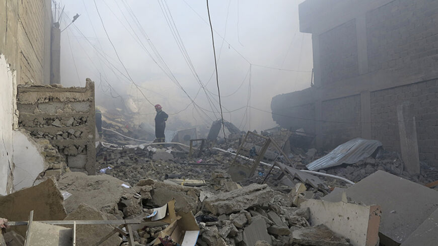 Firefighters inspect a market destroyed after an attack by Iraq security force helicopters in Ramadi, June 8, 2014. More than 420,000 people have already escaped the two main cities of western Anbar province, Falluja and Ramadi, in fighting since the start of the year. REUTERS/ Ali al-Mashhadani (IRAQ - Tags: POLITICS CIVIL UNREST TPX IMAGES OF THE DAY MILITARY) - RTR3SS3E