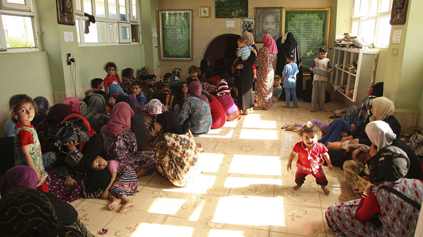 Iraqi Shiite Turkmen Families fleeing the violence in the Iraqi city of Tal Afar, west of Mosul arrive at Shangal, a town in Nineveh province, June 17, 2014.  The mainly Turkmen city of Tal Afar, west of Mosul, fell to Sunni militants late on Sunday, and the Iraqi military said it was sending reinforcement there. The Iraqi army said on state television it had killed a top militant, named Abu Abdul Rahman al-Muhajir, in Mosul in clashes.  Picture taken June 17, 2014. REUTERS/ Ari Jalal (IRAQ - Tags: CIVIL UN