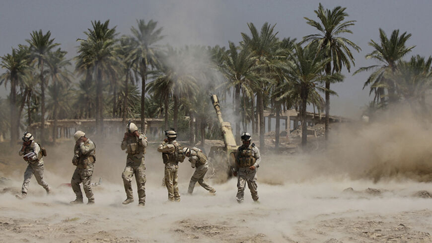 Iraqi soldiers fire artillery during clashes with Sunni militant group Islamic State of Iraq and the Levant (ISIL) in the town of Jurf al-Sakhar, south of Baghdad June 30, 2014. Iraqi troops battled to dislodge the al Qaeda splinter group from the city of Tikrit on Monday after its leader was declared caliph of a new Islamic state in lands seized this month across a swathe of Iraq and Syria. Alarming regional and world powers, the ISIL claimed universal authority when it dropped the local element in its nam