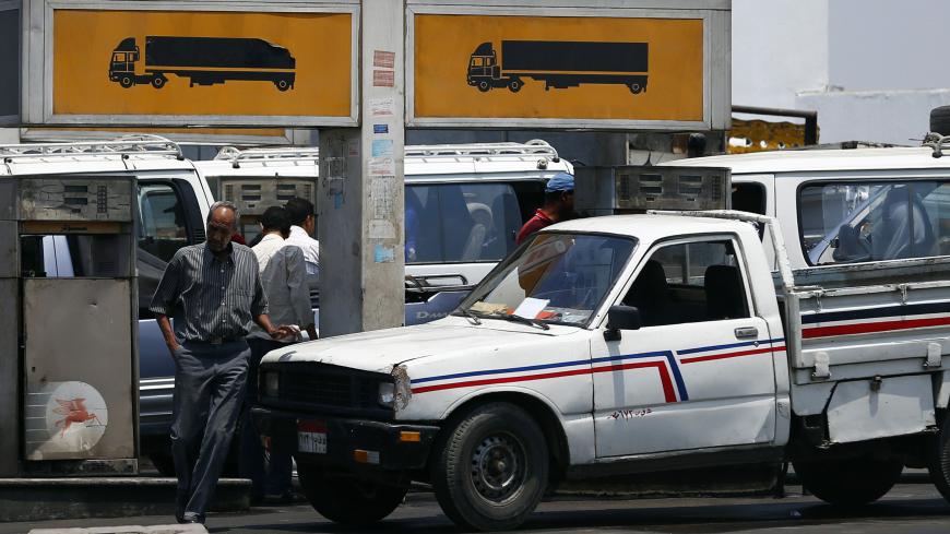 People wait to buy fuel at a petrol station in Cairo July 6, 2014. Egypt's Prime Minister Ibrahim Mehleb has sought to justify politically sensitive subsidy cuts on fuel and natural gas which took effect on Saturday, saying they were a necessary part of fixing an economy hammered by three years of turmoil. Egypt had overnight on Friday slashed its subsidies for car fuel and natural gas, increasing their prices by more than 70 percent. REUTERS/Amr Abdallah Dalsh (EGYPT - Tags: POLITICS BUSINESS ENERGY TRANS
