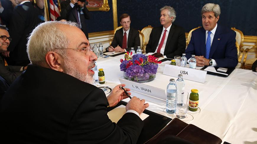 Iran's Foreign Minister Javad Zarif (L) holds a bilateral meeting with U.S. Secretary of State John Kerry (R) on the second straight day of talks over Tehran's nuclear program in Vienna, July 14, 2014. Kerry will press his Iranian counterpart Zarif to make "critical choices" in a second straight day of talks over Tehran's nuclear program on Monday, a U.S. official said. REUTERS/Jim Bourg (AUSTRIA - Tags: POLITICS ENERGY) - RTR3YJOW