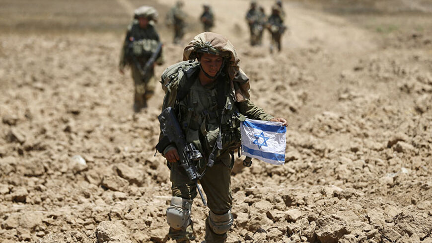 Israeli soldiers from the Givati brigade return to Israel from Gaza August 3, 2014. An Israeli air strike killed at least 10 people and wounded about 30 others on Sunday in a U.N.-run school in the southern Gaza Strip, a Palestinian official said, as dozens died in Israeli shelling of the enclave and Hamas fired rockets at Israel. The Israeli military said it was looking into the reported attack, the second to hit a school in less than a week. Israeli media, on the 27th day of the fighting, reported that mo