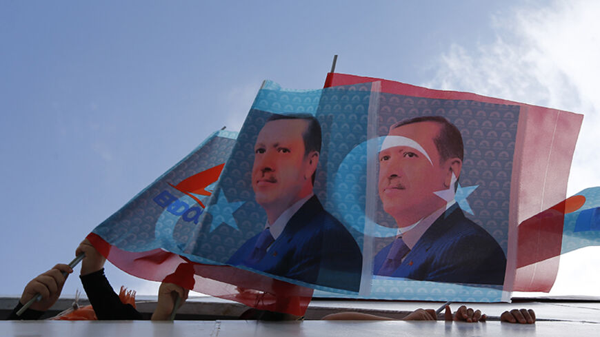 Supporters of Turkey's Prime Minister and presidential candidate Tayyip Erdogan wave flags in a boat on their way to an election rally in Istanbul August 3, 2014. Cheers erupted from the packed stands when Erdogan scored his third goal in a celebrity soccer match to mark the opening of an Istanbul stadium. His orange jersey bore the number 12, a reminder of Erdogan's ambition to become the nation's 12th president in Turkey's first popular vote for its head of state, on Aug. 10. After dominating Turkish poli