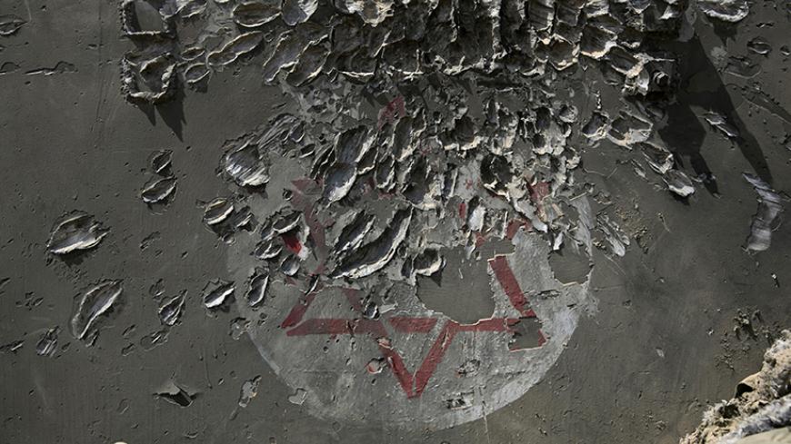 An armoured military ambulance damaged in a Palestinian mortar strike is seen near the border with the Gaza Strip August 4, 2014. Palestinians accused Israel of breaking its own ceasefire on Monday by launching a bomb attack on a refugee camp in Gaza City that killed an eight-year-old girl and wounded 29 other people. An Israeli military spokeswoman said she was checking the report. REUTERS/Baz Ratner (ISRAEL - Tags: POLITICS CIVIL UNREST MILITARY CONFLICT TPX IMAGES OF THE DAY) - RTR415KM