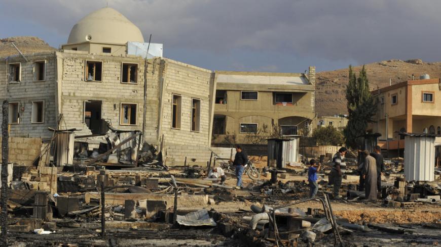A general view shows damage and burnt tents for Syrian refugees from the fighting between Lebanese army soldiers and Islamist militants in the Sunni Muslim border town of Arsal, in eastern Bekaa Valley August 7, 2014. Militant Islamists have mostly withdrawn from the Lebanese border town of Arsal, which they seized at the weekend, taking with them captive Lebanese soldiers, militant and security sources said on Thursday, as a truce to end the deadly battle appeared to hold. REUTERS/Hassan Abdallah (LEBANON 