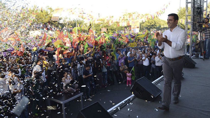 Selahattin Demirtas, co-chairman of the pro-Kurdish Peoples' Democracy Party (HDP) and presidential candidate, speaks during an election rally in Diyarbakir, August 8, 2014. Tayyip Erdogan is set to secure his place in history as Turkey's first popularly-elected president on Sunday, but his tightening grip on power has polarised the nation, worried Western allies and raised fears of creeping authoritarianism. Demirtas was running a distant third. REUTERS/Stringer (TURKEY - Tags: POLITICS ELECTIONS) - RTR41Q