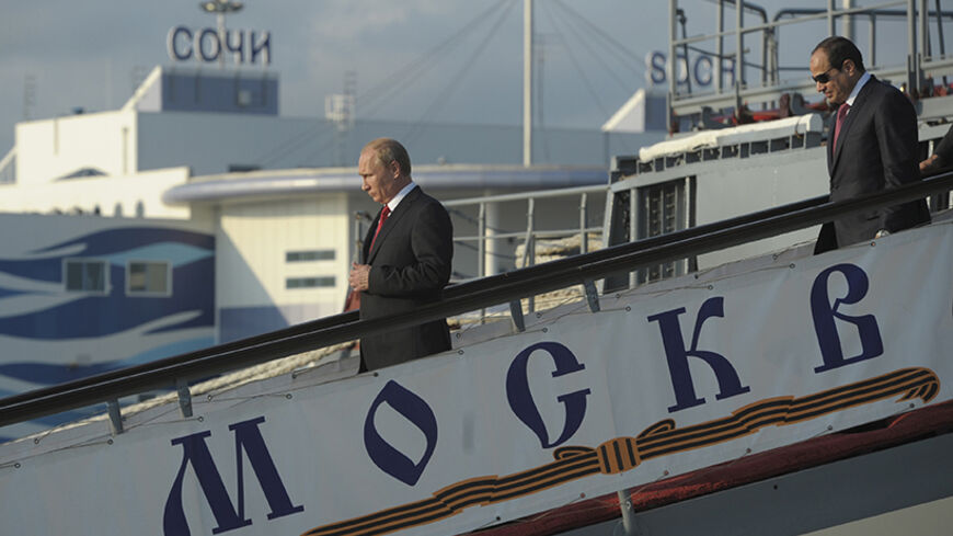 Russia's President Vladimir Putin (L) and his Egyptian counterpart Abdel Fattah al-Sisi leave the guided missile cruiser Moskva at the Black Sea port of Sochi, August 12, 2014. REUTERS/Alexei Druzhinin/RIA Novosti/Kremlin (RUSSIA - Tags: POLITICS MILITARY) ATTENTION EDITORS - THIS IMAGE HAS BEEN SUPPLIED BY A THIRD PARTY. IT IS DISTRIBUTED, EXACTLY AS RECEIVED BY REUTERS, AS A SERVICE TO CLIENTS - RTR4266Z