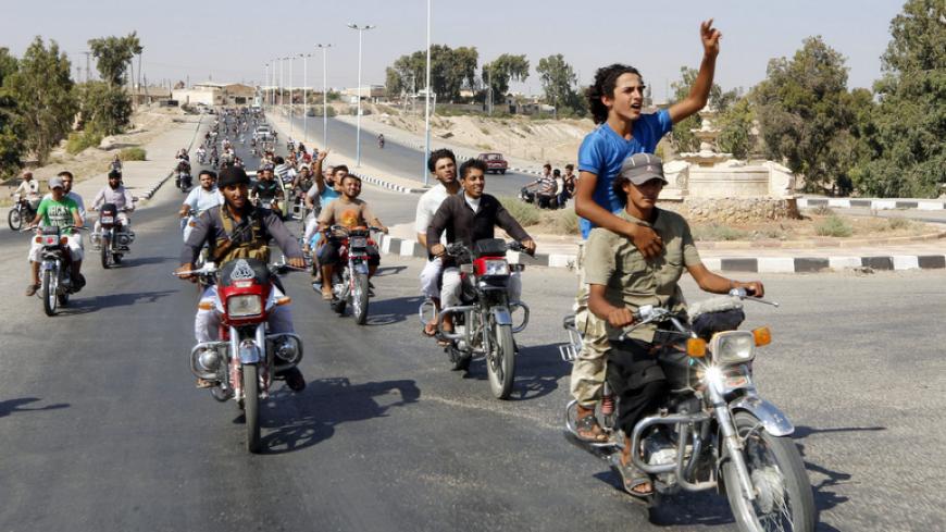 Residents of Tabqa city and Islamic State militants tour the streets in celebration after Islamic State militants took over Tabqa air base in northeast Syria August 24, 2014. Islamic State militants stormed the air base in northeast Syria on Sunday, capturing most of it from government forces after days of fighting over the strategic location, a witness and a monitoring group said. Fighting raged inside the walls of the Tabqa air base, the Syrian army's last foothold in an area otherwise controlled by IS, w