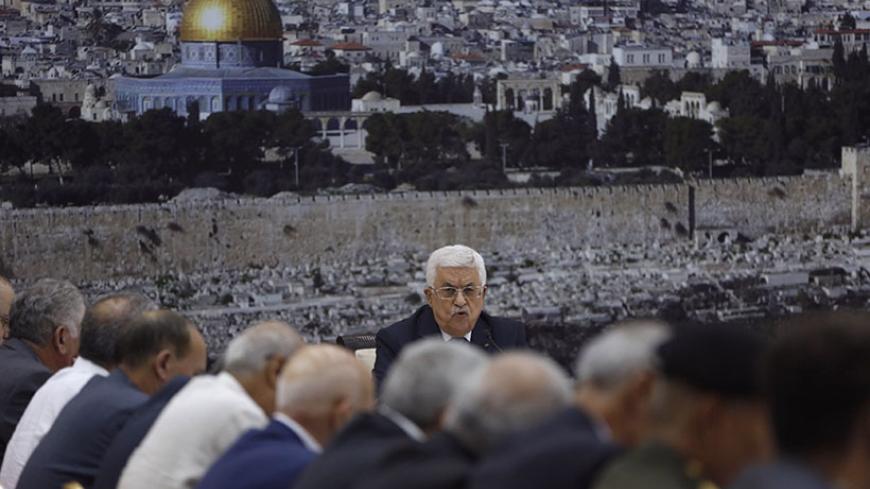 Palestinian President Mahmoud Abbas presides over a meeting with Palestinian leadership in the West Bank city of Ramallah August 26, 2014. Israel has accepted an Egyptian proposal for a Gaza ceasefire, a senior Israeli official said on Tuesday. Egyptian and Palestinian officials said the truce was to take effect at 7 pm (1600 GMT). REUTERS/Mohamad Torokman (WEST BANK - Tags: POLITICS) - RTR43V6J