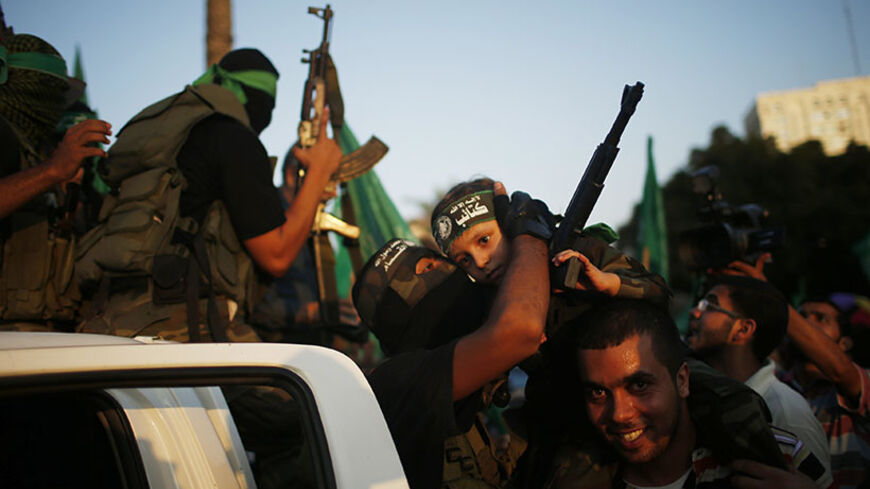 Hamas militants celebrate with people in what they said was a victory over Israel, in Gaza City August 27, 2014. An open-ended ceasefire in the Gaza war held on Wednesday as Prime Minister Benjamin Netanyahu faced strong criticism in Israel over a costly conflict with Palestinian militants in which no clear victor emerged.
REUTERS/Mohammed Salem (GAZA - Tags: CIVIL UNREST CONFLICT POLITICS) - RTR43ZYV