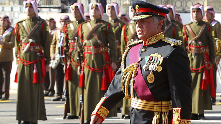 Jordan's King Abdullah walks during the opening of the 17th Ordinary Session of Parliament in Amman November 3, 2013. REUTERS/Muhammad Hamed (JORDAN - Tags: POLITICS ROYALS) - RTX14YCU