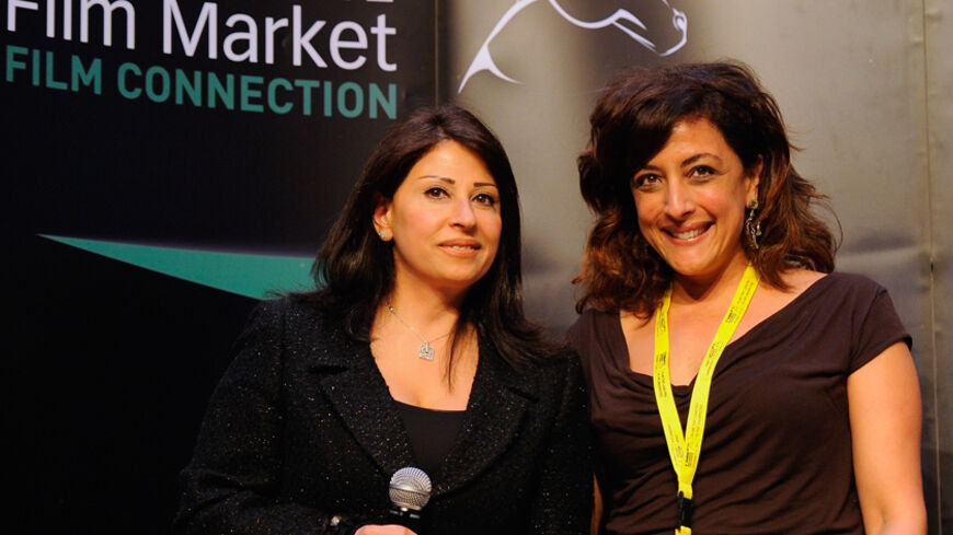 DUBAI, UNITED ARAB EMIRATES - DECEMBER 11: Director Najwa Najjar (R) receives the DIFF award during the Dubai Film Connection (DFC) award ceremony on day five of the 8th Annual Dubai International Film Festival held at the Madinat Jumeriah Complex on December 11, 2011 in Dubai, United Arab Emirates. (Photo by Andrew H. Walker/Getty Images for DIFF)