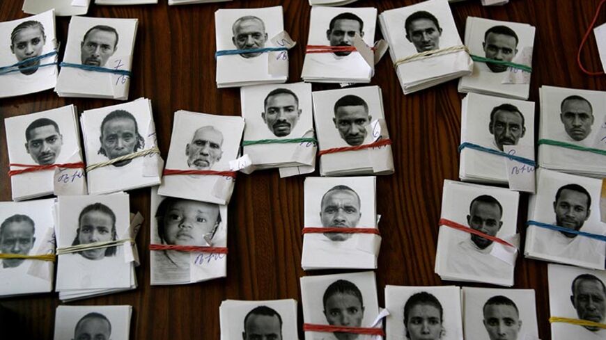 Passport pictures for Ethiopians, who are awaiting immigration to Israel, lie on a table in Gondar March 8, 2007. More than 5000 Ethiopians are waiting to migrate to Israel to reunite with their families, according to Israel's Jewish Agency. Photo taken March 8, 2007.    REUTERS/Eliana Aponte (ETHIOPIA) - RTR1NHQJ
