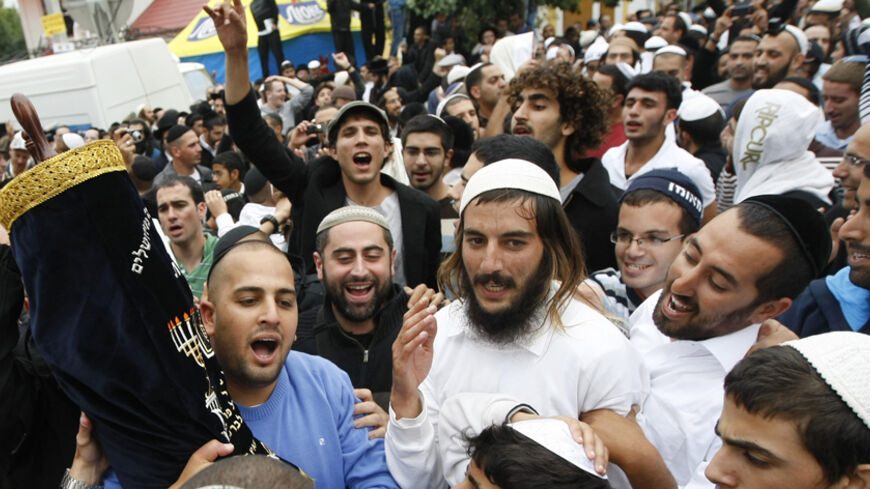 Ultra orthodox Jewish men pray near the tomb of Rabbi Nachman of Breslov in the town of Uman, some 200 km (124 miles) south of Kiev, September 8, 2010. Thousands of Jewish pilgrims arrive every year on Rosh Hashana, the Jewish new year, at the tomb of Rabbi Nachman of Breslov in Uman. REUTERS/Konstantin Chernichkin (UKRAINE - Tags: RELIGION) - RTR2I2LA