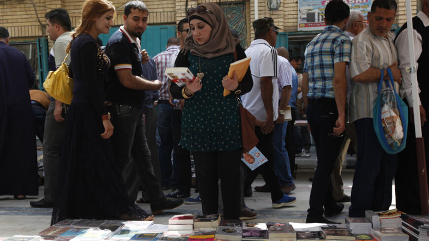 Residents shop for books at Mutanabi Street in Baghdad April 18, 2014. REUTERS/Ahmed Saad (IRAQ - Tags: SOCIETY) - RTR3LSX2