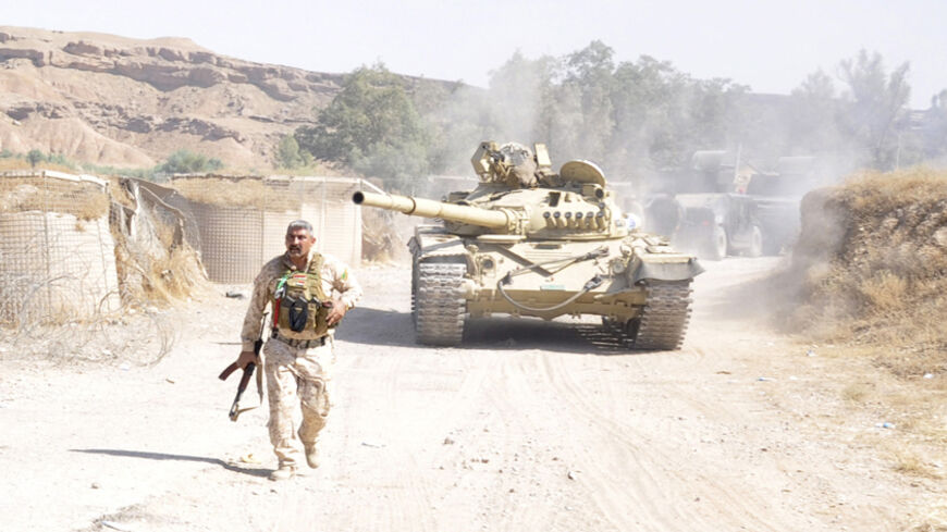 A tank is pictured as Iraqi security forces patrol after clashes with militants of the Islamic State, formerly known as the Islamic State in Iraq and the Levant (ISIL), in the Hamrin mountains in Diyala province July 16, 2014. The Iraqi army and allied Shi'ite militia forces are trying to push back the Sunni insurgents of the al Qaeda offshoot, who swept through northern Iraq last month to within 70 km (45 miles) of Baghdad. Picture taken July 16, 2014. REUTERS/Stringer (IRAQ - Tags: CIVIL UNREST POLITICS C