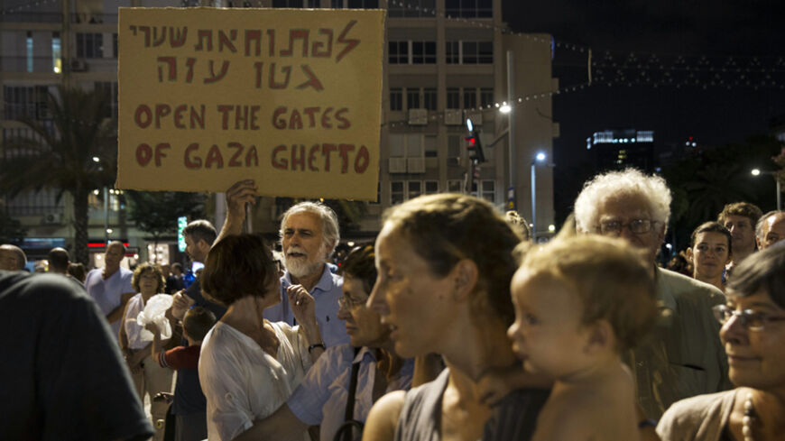 A man holds up a placard during a peace rally in Tel Aviv's Rabin Square August 16, 2014. The protesters were demonstrating in favour of a peaceful political agreement, to end the month-long conflict in Gaza, between the Israeli and Palestinian governments.
REUTERS/Baz Ratner (ISRAEL - Tags: POLITICS CIVIL UNREST) - RTR42O65
