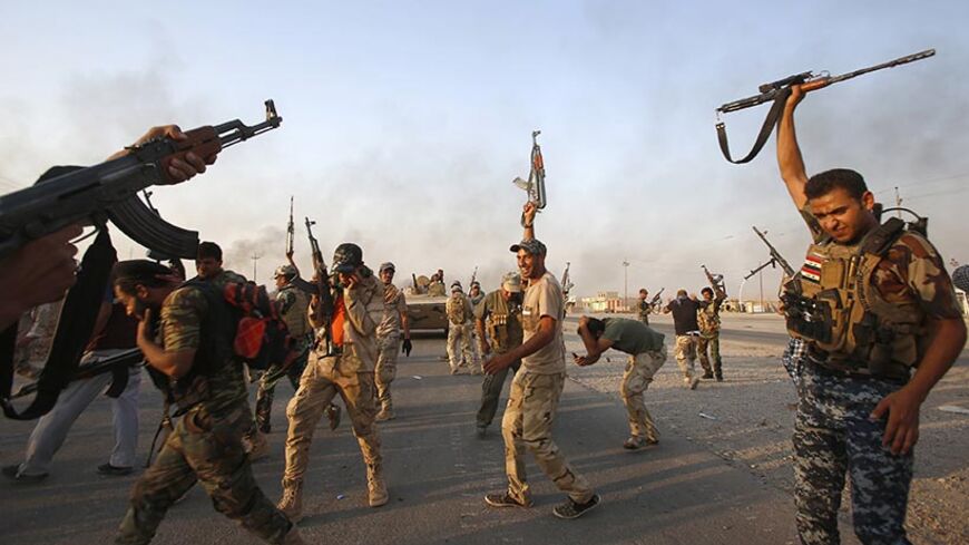 Iraqi Shiite militia fighters fire their weapons as they celebrate breaking a long siege of Amerli by Islamic State militants September 1, 2014.  REUTERS/Youssef Boudlal (IRAQ - Tags: CIVIL UNREST POLITICS MILITARY TPX IMAGES OF THE DAY) - RTR44KD4