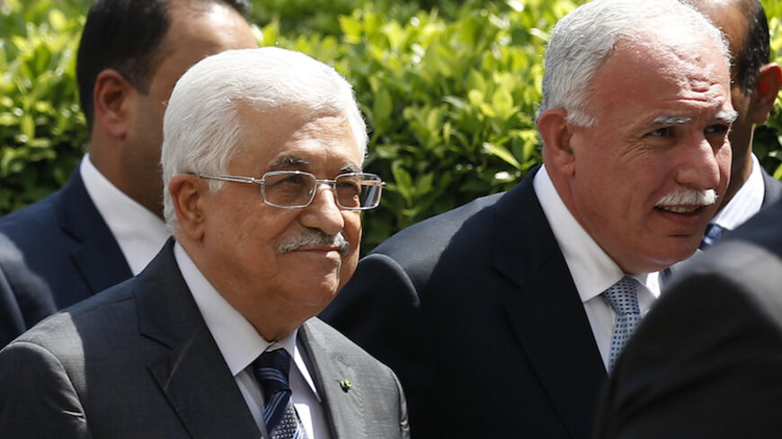 Palestinian President Mahmoud Abbas and  his foreign minister Riyad al-Maliki (R) arrive for an Arab League Foreign Ministers emergency meeting at the league's headquarters in Cairo September 7, 2014. Arab foreign ministers meeting in Cairo on Sunday are expected to issue a resolution backing Iraqi efforts to confront militants who have overrun large areas of Iraq and Syria and declared a cross-border Islamic caliphate, diplomats said.  REUTERS/Mohamed Abd El Ghany (EGYPT - Tags: POLITICS) - RTR458TQ