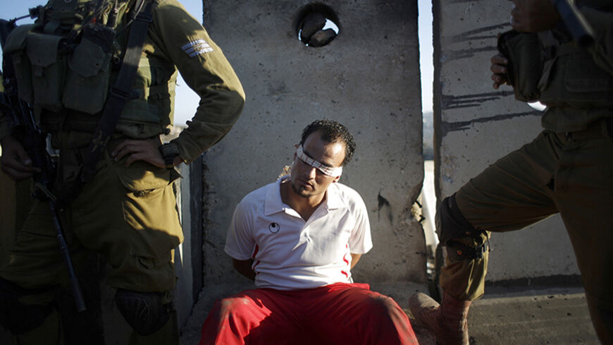 Israeli soldiers detain a Palestinian during clashes at a protest against the Jewish settlement of Ofra, in the West Bank village of Silwad, near Ramallah September 12, 2014. REUTERS/Mohamad Torokman (WEST BANK - Tags: POLITICS CIVIL UNREST TPX IMAGES OF THE DAY) - RTR460SU