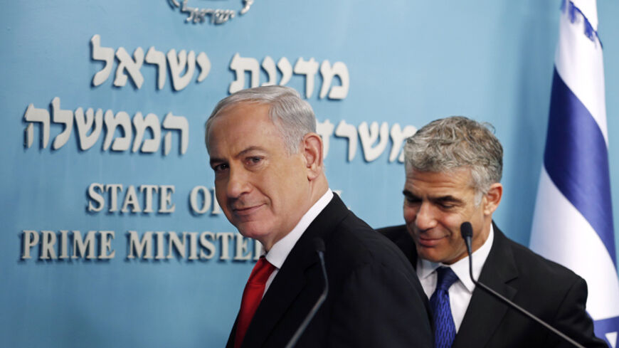 Israeli Prime Minister Benjamin Netanyahu (L) and Finance Minister Yair Lapid leave after a joint news conference in Jerusalem July 3, 2013. Israel initiated a tender for two new private seaports to operate beside existing government-owned ports in Haifa and Ashdod in a bid to stir up competition and lower the costs of good in Israel. Each new port will cost about $1 billion to build. REUTERS/Ronen Zvulun (JERUSALEM - Tags: POLITICS) - RTX11AV6