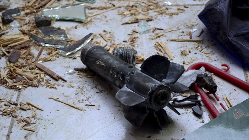 A mortar shell is seen among debris after six mortar bombs landed in the Jaramana district of southeast Damascus October 31, 2013, in this handout picture released by Syria's national news agency SANA. The mortar bombs killed at least two people and wounded fifteen on Thursday when they exploded on the edge of the Syrian capital Damascus, state media said. REUTERS/SANA/Handout via Reuters (SYRIA - Tags: CONFLICT CIVIL UNREST) ATTENTION EDITORS - THIS IMAGE WAS PROVIDED BY A THIRD PARTY. FOR EDITORIAL USE ON