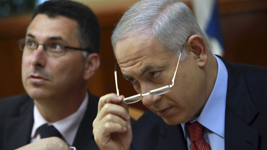 Israel's Prime Minister Benjamin Netanyahu (R) and Education Minister Gideon Saar attend the weekly cabinet meeting in Jerusalem October 18, 2009. Netanyahu promised a lengthy diplomatic battle to "delegitimise" United Nations charges that Israel committed war crimes in the Gaza Strip, an official said on Saturday. REUTERS/David Silverman/Pool (JERUSALEM POLITICS) - RTXPR7B