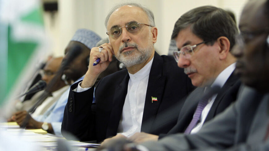 Iranian Foreign Minister Ali Akbar Salehi (L) looks past his Turkish counterpart Ahmet Davutoglu during the opening of a ministerial meeting in the Saudi Red Sea city of Jeddah, by the Organisation of Islamic Cooperation (OIC) on May 13, 2013. The OIC urged its member states to make generous contributions at this week's main donors conference on Mali to be held in Brussels, which aims to raise funds to repair the damage caused by the war against Islamists in the African country. AFP PHOTO/STR        (Photo 