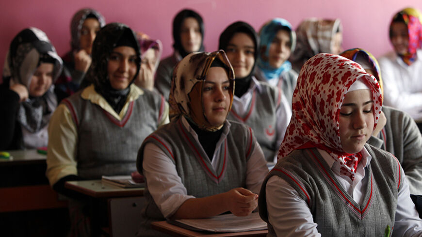 Turkish girls attend a class at the Kazim Karabekir Girls' Imam-Hatip School in Istanbul February 10, 2010. The imam-hatip network is a far cry from the western stereotype of the madrassa as an institution that teaches the Koran by rote and little else. Originally founded to educate Muslim religious functionaries in the 1920s, the imam-hatip syllabus devotes only around 40 percent of study to religious subjects like Arabic, Islamic jurisprudence and rhetoric. The rest is given over to secular topics.  To ma