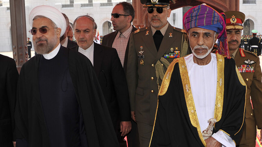 Oman's Sultan Qaboos bin Said (R) walks with Iran's President Hassan Rouhani upon Rouhani's arrival in Muscat March 12, 2014. REUTERS/Sultan Al Hasani (OMAN - Tags: POLITICS ROYALS) - RTR3GQAH