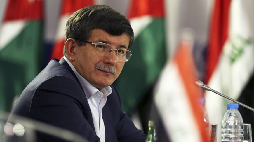 Turkish Foreign Minister Ahmet Davutoglu attends the opening of a meeting of foreign ministers at the Zaatari refugee camp in the Jordanian city of Mafraq, near the border with Syria, May 4, 2014. Foreign ministers of major refugee hosting countries attended a one-day meeting in the Zaatari refugee camp to discuss a resolution for the Syrian refugee crisis. The meeting - the third for countries harbouring the largest number of Syrian refugees - brought together Foreign Ministers from Jordan, Lebanon, Egypt,