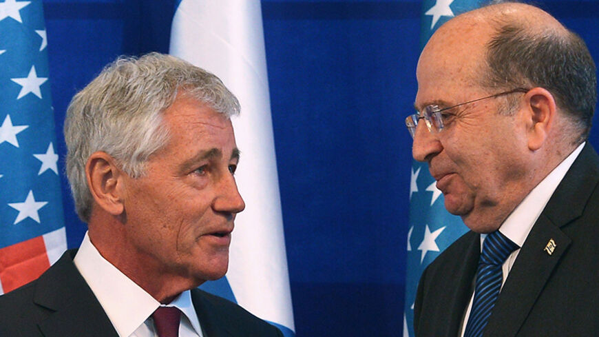 Israeli Defense Minister Moshe Ya'alon (R) shakes hands with U.S. Defense Secretary Chuck Hagel during a joint news conference at The Kirya, the Israeli Defense Force headquarters, in Tel Aviv May 15, 2014. REUTERS/Mandel Ngan/Pool (ISRAEL - Tags: POLITICS MILITARY) - RTR3PAYP
