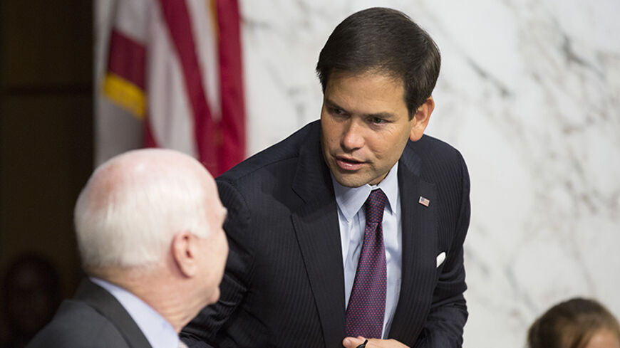 Senator Marco Rubio (R-FL) speaks with Senator John McCain (R-AZ) as U.S. Secretary of State John Kerry testifies during a Senate Foreign Relations Committee hearing on "U.S. Strategy to Defeat the Islamic State in Iraq and the Levant" on Capitol Hill in Washington September 17, 2014. REUTERS/Joshua Roberts (UNITED STATES - Tags: POLITICS CIVIL UNREST CONFLICT) - RTR46NOK