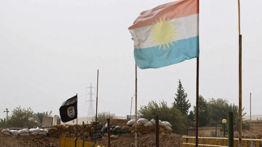 A Kurdish flag and a Islamic State flag flutter on each end of the Mullah Abdullah bridge in southern Kirkuk September 29, 2014. Members of the Kurdish security forces and the Islamic State are holding fort behind sandbags on different ends of the bridge. REUTERS/Ako Rasheed (IRAQ - Tags - Tags: POLITICS CIVIL UNREST CONFLICT) - RTR4884H