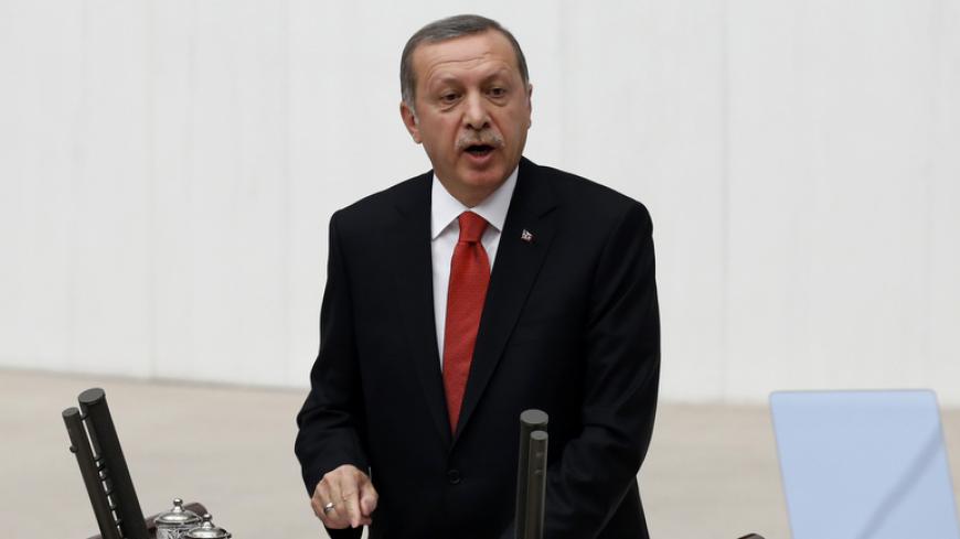 Turkey's President Tayyip Erdogan addresses the Turkish Parliament during a debate marking the reconvene of the parliament in Ankara October 1, 2014. Turkey will fight against Islamic State and other "terrorist" groups in the region but will stick to its aim of seeing Syrian President Bashar al-Assad removed from power, Erdogan said on Wednesday. REUTERS/Umit Bektas (TURKEY - Tags: POLITICS) - RTR48IMI