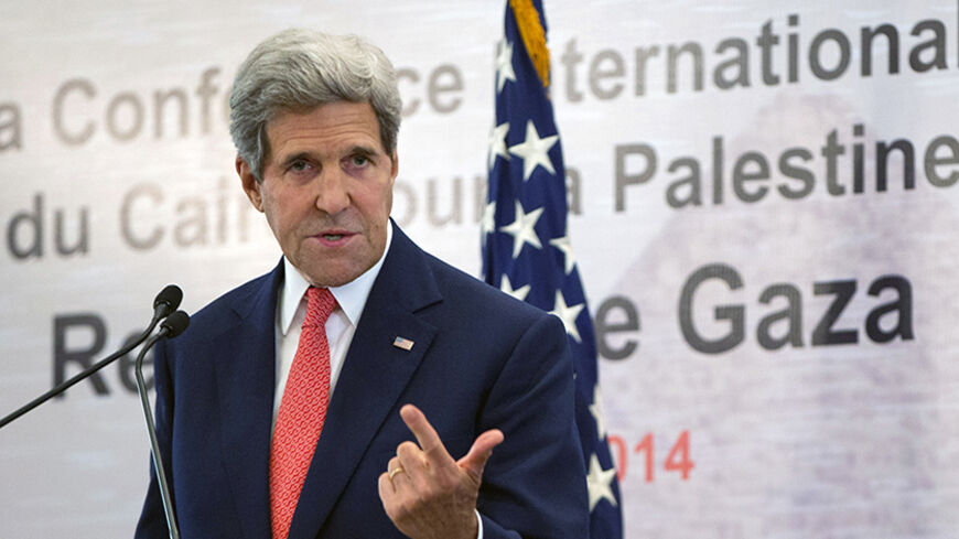 U.S. Secretary of State John Kerry speaks during a joint news conference with Egypt's Foreign Minister Sameh Shukri in Cairo October 12, 2014. Kerry said on Sunday the United States was deeply concerned about what he called the "tragedy" in the Syrian town of Kobani, where Islamic State fighters have been tightening their grip. REUTERS/Carolyn Kaster/Pool (EGYPT - Tags: POLITICS) - RTR49W49