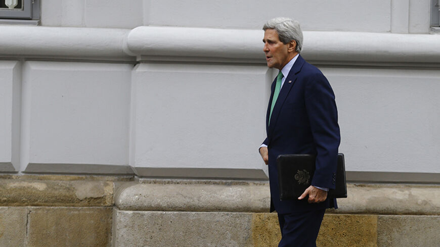 U.S. Secretary of State John Kerry arrives prior to a meeting with EU foreign policy chief Catherine Ashton and Iranian Foreign Minister Mohammad Javad Zarif, at a hotel in Vienna October 15, 2014. World powers and Iran are not discussing extending a late November deadline for reaching an accord over Tehran's nuclear programme, a senior U.S. official said on Wednesday, adding there was still time to strike a deal. REUTERS/Leonhard Foeger (AUSTRIA - Tags: POLITICS ENERGY) - RTR4A9ED