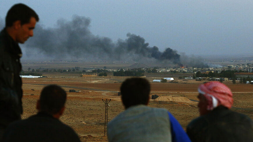 Turkish Kurds watch as smoke rises over the Syrian town of Kobani, from a hill near the Mursitpinar border crossing, on the Turkish-Syrian border in the southeastern town of Suruc in Sanliurfa province October 24, 2014. REUTERS/Kai Pfaffenbach (TURKEY - Tags: MILITARY CONFLICT POLITICS CIVIL UNREST) - RTR4BHAZ