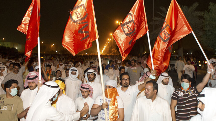 Supporters of Kuwaiti former member of parliament and opposition politician Musallam al-Barrak wave flags as they march towards the central prison in Andulos, after a ruling sentenced Barrak to jail for insulting the emir, April 15, 2013. Barrak was sentenced to five years in jail on Monday for insulting the emir, his lawyer said, in a ruling that brought thousands of people to the streets in protest. The Kuwaiti criminal court found Barrak guilty of insulting Sheikh Sabah al-Ahmad al-Sabah in a speech in O