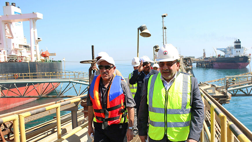 The Iraqi Minister of Oil Adel Abdel Mahdi (R) takes a tour a floating platform for oil tankers on September 21, 2014, offshore from the southern Iraqi port city of Al Faw, 90 kilometres south of Basra. An OPEC report on September 10, 2014 said that demand for oil would grow by 1.05 million barrels per day in 2014 to 91.2 million in 2015, trimming 50,000 barrels from the previous outlook. Demand in 2015 is expected to grow 1.19 million barrels per day, 20,000 barrels a day fewer than before, the cartel sa