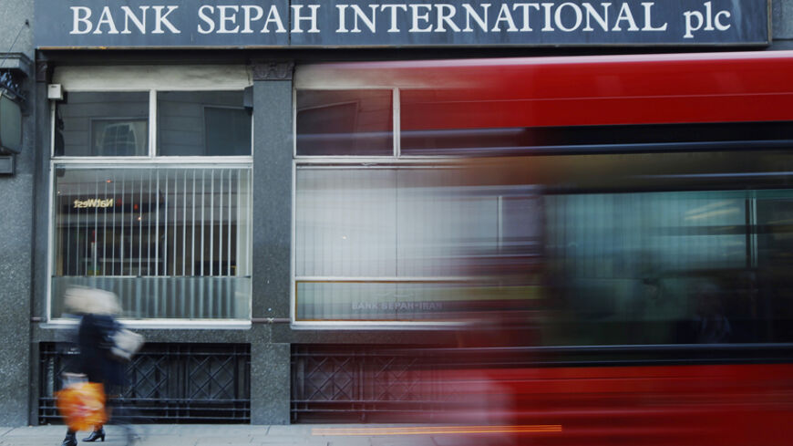 A red London bus passes a branch of Iranian owned Bank Sepah International in London December 22, 2011. Hit by international sanctions, the Iranian banks in London linger on, unable to take on new business. The pressure on them is rising. Last month, the UK forbid its banks to do any business with Iranian banks after a new report from a nuclear watchdog highlighted further concerns about the possible military dimensions to Iran's nuclear programme.  REUTERS/Luke MacGregor  (BRITAIN - Tags: BUSINESS POLITICS