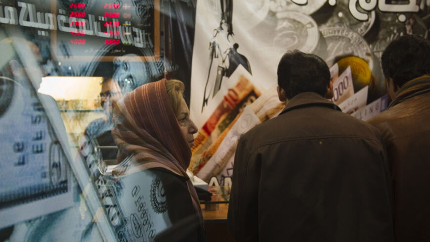 EDITORS' NOTE: Reuters and other foreign media are subject to Iranian restrictions on leaving the office to report, film or take pictures in Tehran.

An Iranian woman stands in a currency exchange shop in northern Tehran January 3, 2012. The Iranian rial fell to a record low against the dollar on Tuesday following U.S. President Barack Obama signing a bill on  imposing fresh sanctions against the country's central bank.    REUTERS/Morteza Nikoubazl (IRAN - Tags: BUSINESS POLITICS) - RTR2VU75