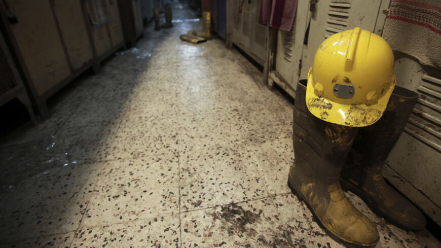 A boot and a helmet are seen in a changing room used by coal miners after a mining disaster in Soma, a district in Turkey's western province of Manisa May 14, 2014. Rescuers were still trying to reach parts of the coal mine in Soma, 480 km (300 miles) southwest of Istanbul, almost 48 hours after fire knocked out power and shut down the ventilation shafts and elevators, trapping hundreds underground. At least 282 people have been confirmed dead, mostly from carbon monoxide poisoning, and hopes are fading of 