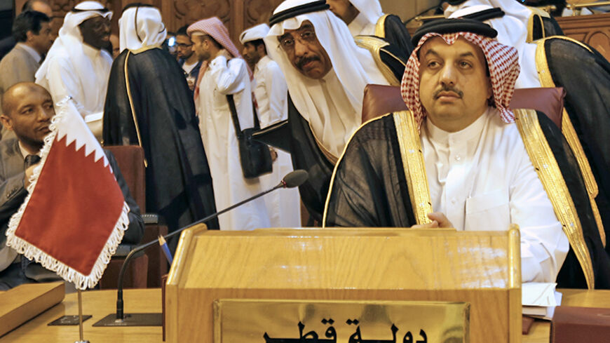 Qatar's Foreign Minister Khalid bin Mohammed Al Attiyah (front) attends an extraordinary session of the Arab League at the league's headquarters in Cairo July 14, 2014. Egypt launched an initiative on Monday to halt fighting between Israel and Palestinian militants, proposing a ceasefire to be followed by talks in Cairo on settling the conflict in which Gaza authorities say more than 170 people have died. REUTERS/Amr Abdallah Dalsh  (EGYPT - Tags: POLITICS CIVIL UNREST) - RTR3YNM0