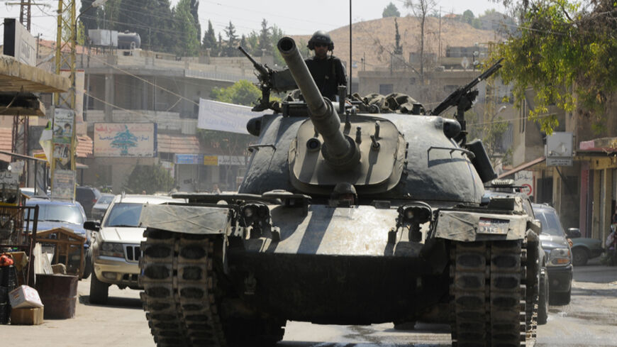 Lebanese Army soldiers on a tank advance towards the Sunni Muslim border town of Arsal, in eastern Bekaa Valley August 7, 2014. Militant Islamists have mostly withdrawn from the Lebanese border town of Arsal, which they seized at the weekend, taking with them captive Lebanese soldiers, militant and security sources said on Thursday, as a truce to end the deadly battle appeared to hold. REUTERS/Hassan Abdallah (LEBANON - Tags: POLITICS CIVIL UNREST MILITARY TPX IMAGES OF THE DAY) - RTR41KAS